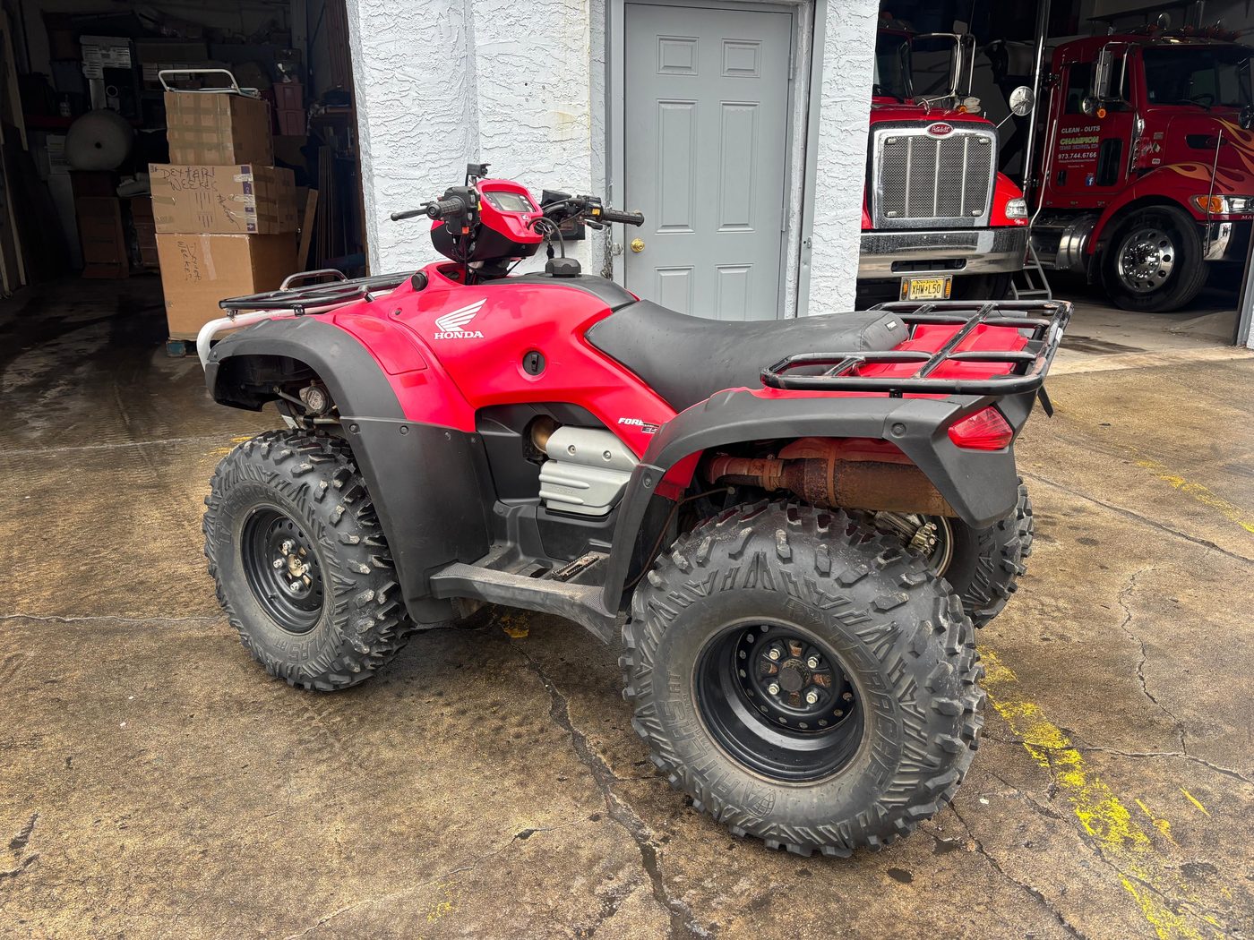 Red Honda Foreman ATV at warehouse
