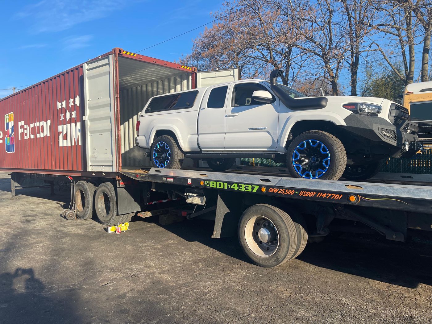 Toyota Tacoma being loaded into shipping container